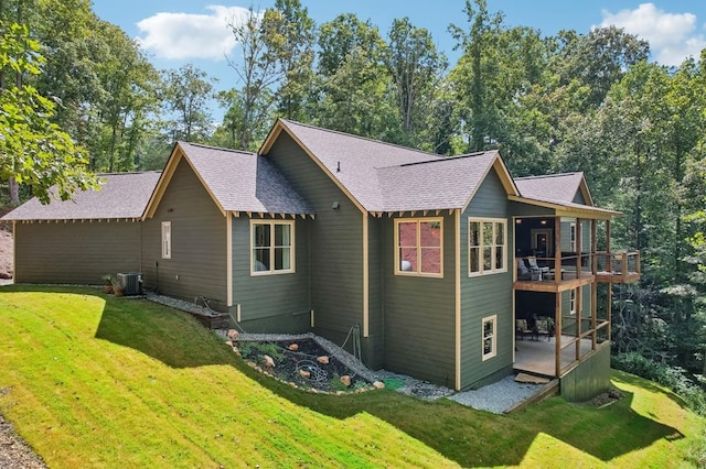 exterior space featuring a front yard and central AC unit