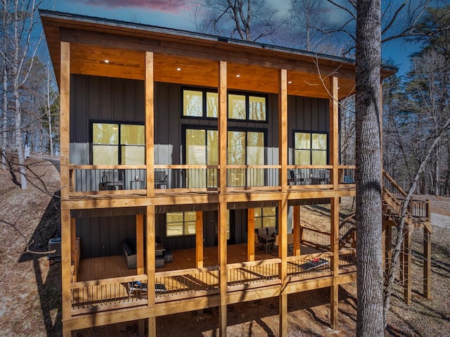 back of house at dusk with board and batten siding