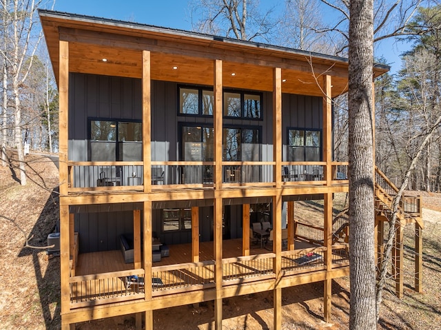 rear view of property with board and batten siding