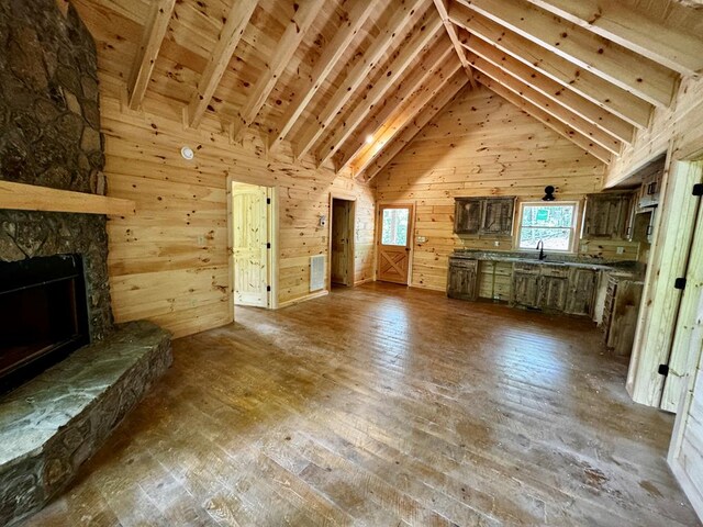 65 Christopher Dr, Ellijay, GA 30540 - unfurnished living room with wood walls, hardwood / wood-style floors, a fireplace, high vaulted ceiling, and wooden ceiling with exposed beams