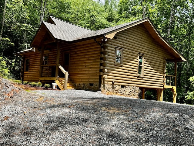 65 Christopher Dr, Ellijay, GA 30540 - view of property exterior with log exterior, a shingled roof, crawl space, and gravel driveway