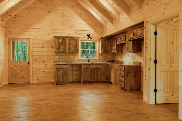 65 Christopher Dr, Ellijay, GA 30540 - kitchen featuring light wood-style floors, healthy amount of natural light, brown cabinetry, and wooden walls