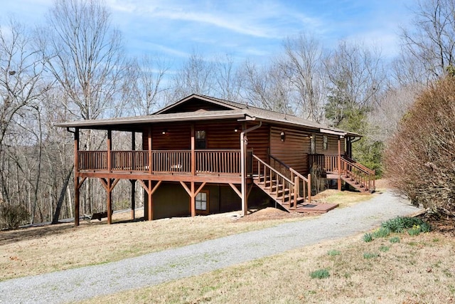 view of front of property with stairs and a wooden deck