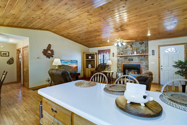 dining room featuring vaulted ceiling, wooden ceiling, light wood finished floors, and ceiling fan