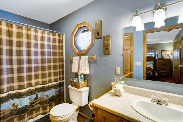 ensuite bathroom featuring vanity, a shower with shower curtain, ensuite bath, toilet, and a textured wall