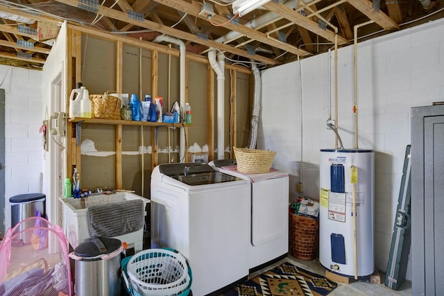 laundry room featuring washer and clothes dryer, water heater, concrete block wall, and a sink