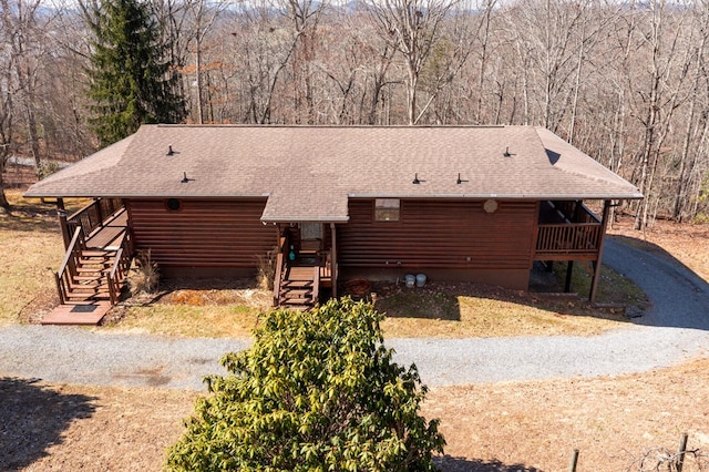 exterior space with roof with shingles