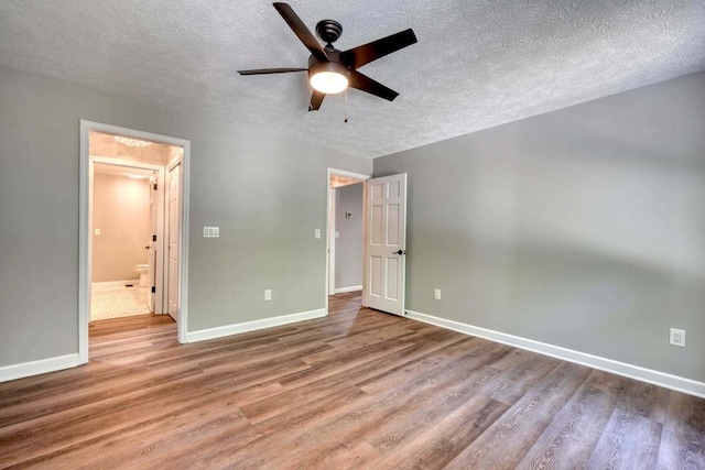 unfurnished bedroom with a textured ceiling, light hardwood / wood-style flooring, and ceiling fan