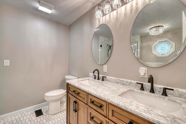 bathroom featuring vanity, tile patterned flooring, and toilet