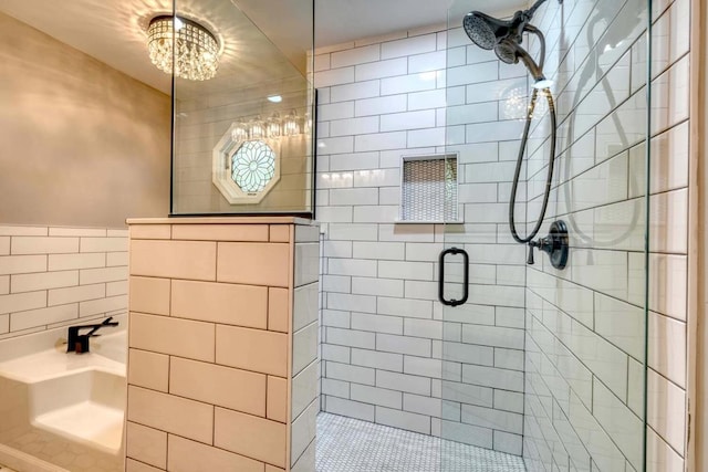 bathroom with tile walls and a shower with shower door