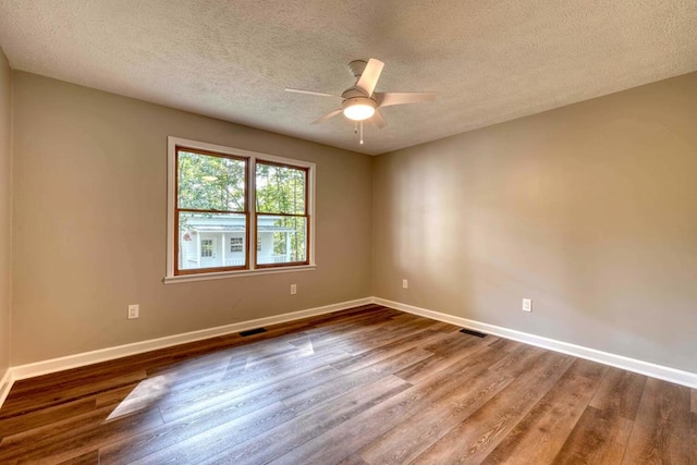 spare room featuring hardwood / wood-style floors, a textured ceiling, and ceiling fan