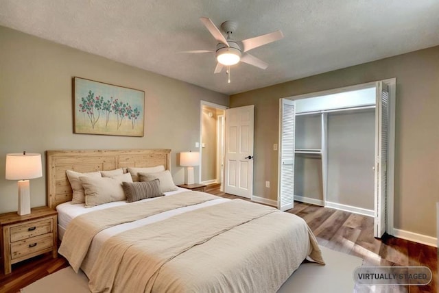 bedroom with dark hardwood / wood-style flooring, a closet, and ceiling fan