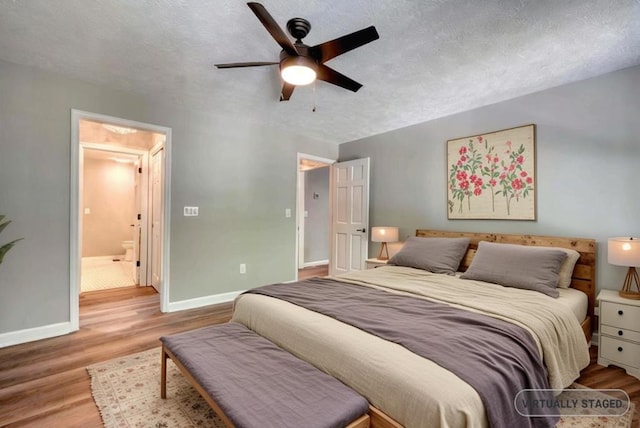 bedroom featuring ceiling fan, a textured ceiling, and light wood-type flooring