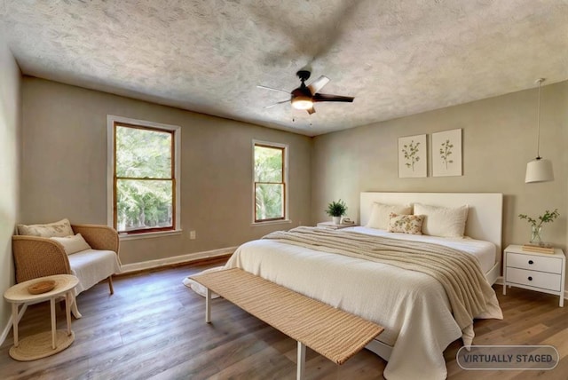 bedroom featuring hardwood / wood-style floors and ceiling fan