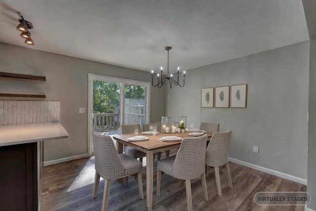 dining area featuring wood-type flooring and a notable chandelier