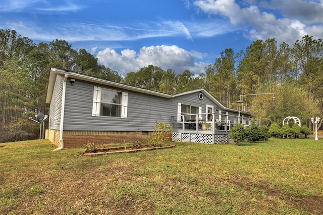 back of property featuring a lawn