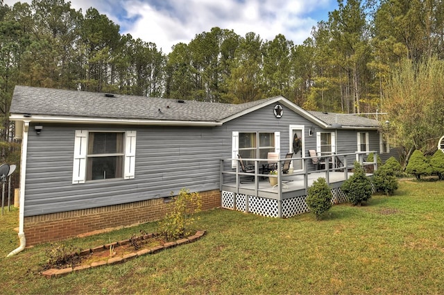 back of house featuring a yard and a deck