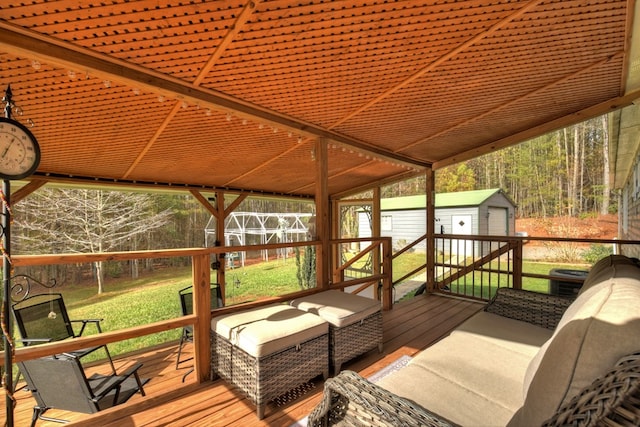 wooden terrace featuring a storage unit and a yard