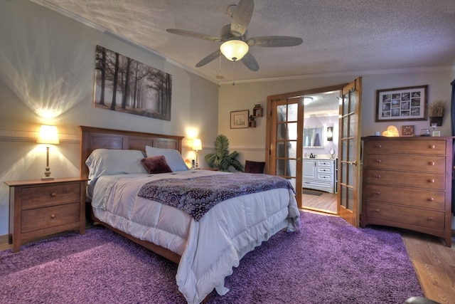 bedroom with ceiling fan, french doors, crown molding, wood-type flooring, and a textured ceiling