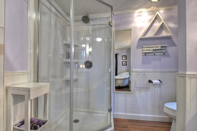 bathroom featuring hardwood / wood-style floors, toilet, a textured ceiling, and an enclosed shower