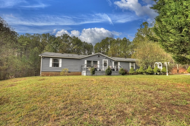 view of front of house featuring a deck and a front lawn