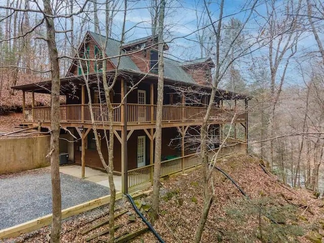 view of property exterior with a deck and a patio area