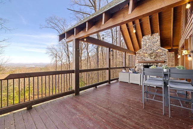 wooden terrace with a fireplace