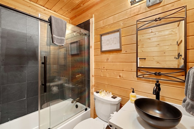 full bathroom with wood walls, enclosed tub / shower combo, vanity, wood ceiling, and toilet