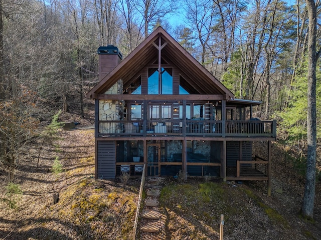 back of property with a wooden deck