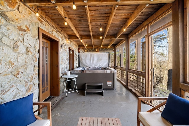 unfurnished sunroom with wood ceiling