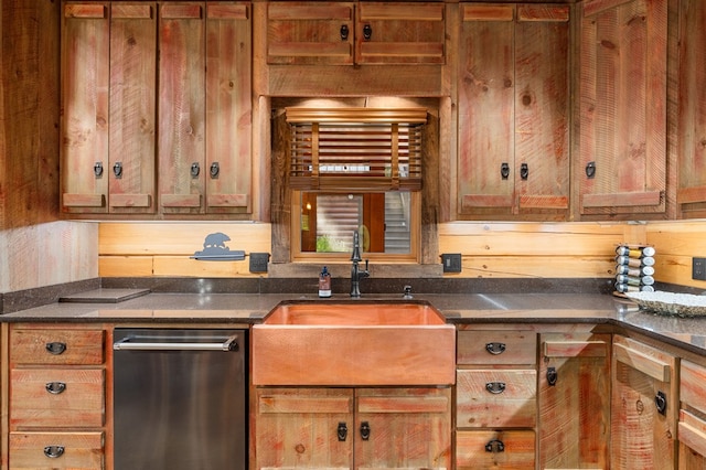 kitchen with dishwasher, sink, and wood walls