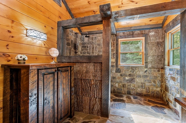 bathroom featuring lofted ceiling and wooden walls