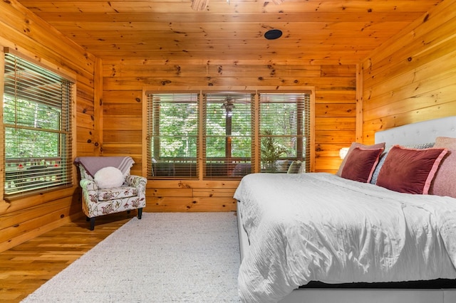 bedroom with wooden walls and wooden ceiling