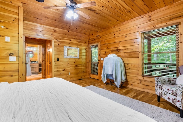 bedroom with wood ceiling, ceiling fan, hardwood / wood-style floors, and wood walls