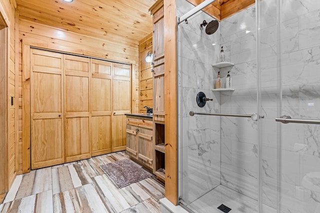 bathroom featuring an enclosed shower and wood walls