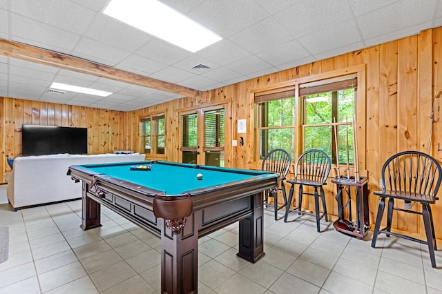 game room featuring wooden walls and a paneled ceiling