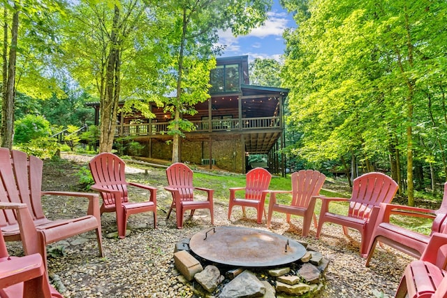 view of patio featuring a wooden deck and an outdoor fire pit