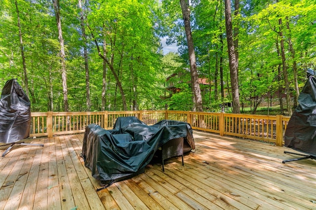 wooden deck with a grill