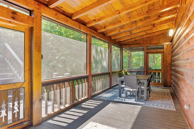 sunroom / solarium featuring vaulted ceiling with beams and wooden ceiling