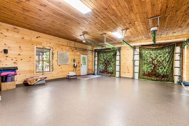 garage with wood ceiling and wooden walls