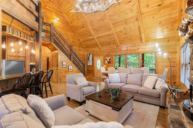 living room featuring wood ceiling, high vaulted ceiling, and wood walls