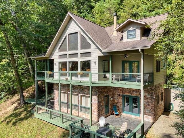 back of property with a balcony, ceiling fan, and a patio