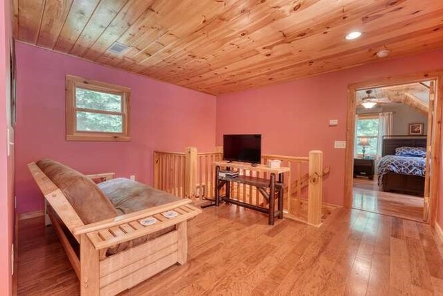 dining room with wood ceiling, light hardwood / wood-style flooring, sink, and wooden walls