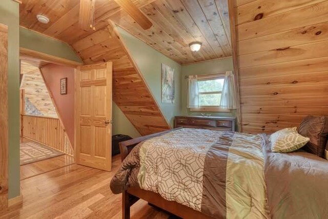 living room with wood walls, a high ceiling, hardwood / wood-style flooring, and ceiling fan