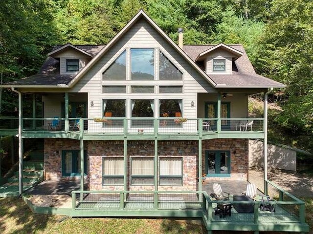 bedroom featuring access to exterior, ceiling fan, wood-type flooring, and french doors