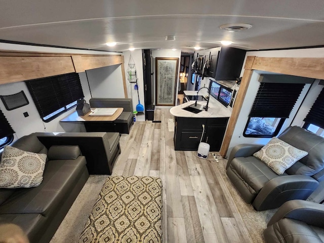 living area with visible vents and light wood-style flooring