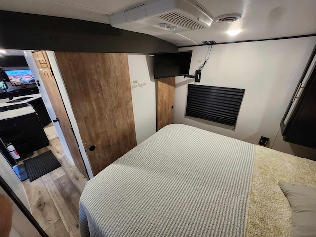 bedroom featuring visible vents and wood finished floors