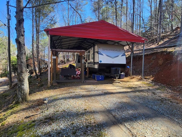 view of car parking featuring a detached carport and driveway