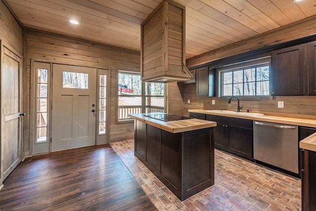 kitchen featuring a kitchen island, sink, wooden counters, black electric stovetop, and stainless steel dishwasher