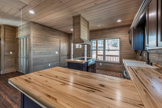 kitchen with dark wood-type flooring, dark brown cabinetry, sink, wood walls, and wooden ceiling